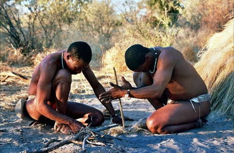 san tribesmen making fire 