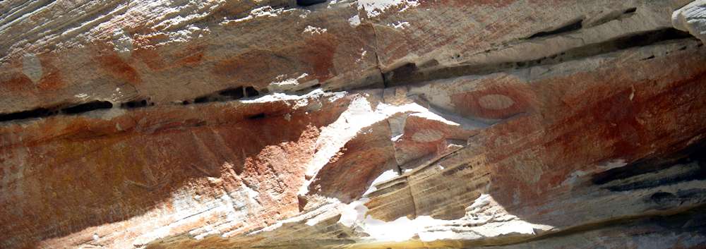 Carnarvon Gorge artwork with Che-Ka-Ra  pendants and engravings of an emu print and a pair of kangaroo prints